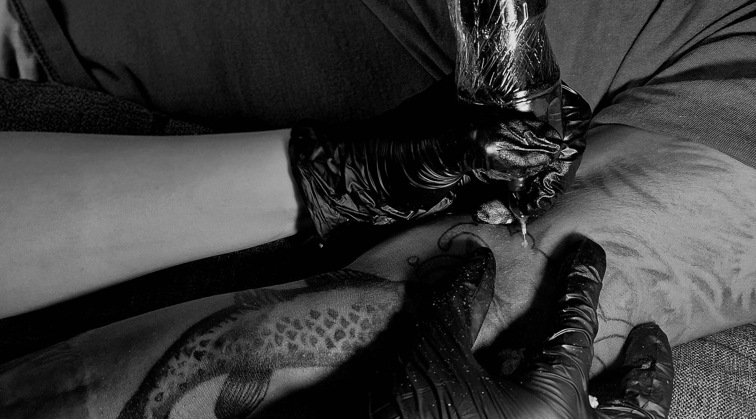 Artist tattooing a client